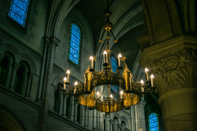 Low angle view of illuminated lamp in building