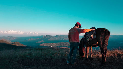 Man with traditional clothing against sky