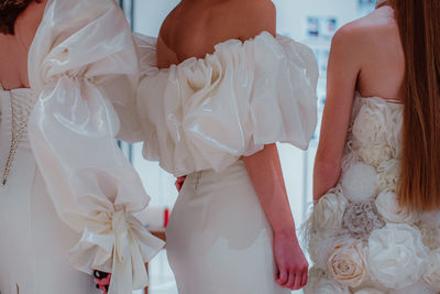 White haute couture silky bridal dresses. fashion shot. preparation before the fashion show