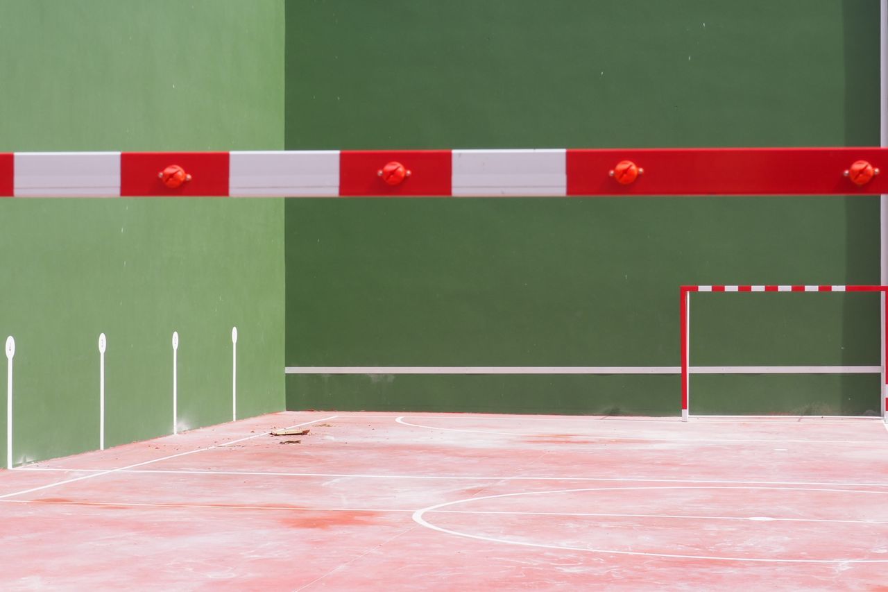 sport, red, no people, absence, green color, white color, court, wall - building feature, flooring, architecture, indoors, built structure, multi colored, empty, day, competition, relaxation, pattern, stadium, dividing line