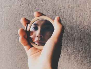 High angle portrait of woman with hand on wall at home
