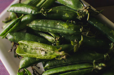 High angle view of green peas in container