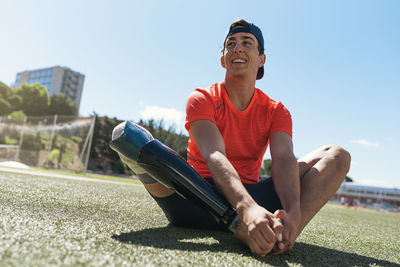 Full length of man sitting against sky