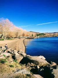 Scenic view of river against clear blue sky