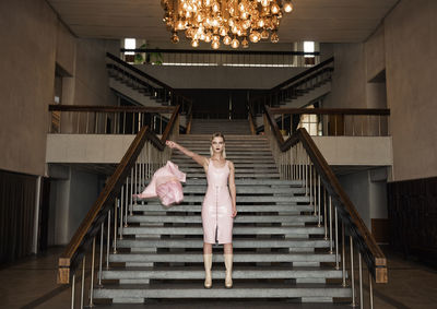 Low angle view of woman walking on staircase