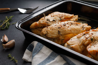 High angle view of baked chicken in dish on table