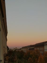 Buildings against clear sky during sunset