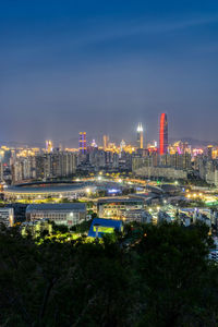 High angle view of illuminated buildings against sky at night