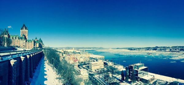 Chateau frontenac hotel by st lawrence river against clear blue sky