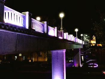 Illuminated city against sky at night