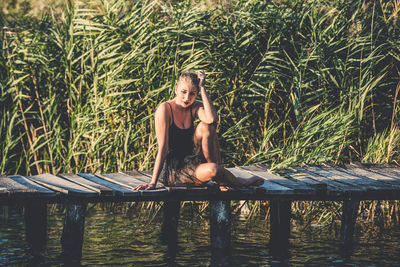 Young woman sitting on table