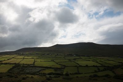 Scenic view of mountains against cloudy sky