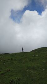 Man standing on field against sky