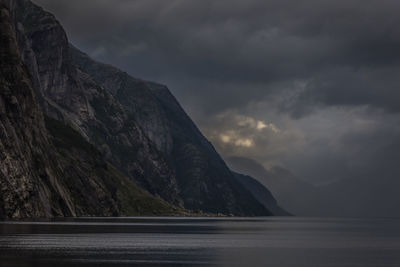 Scenic view of fjord and mountains against sky