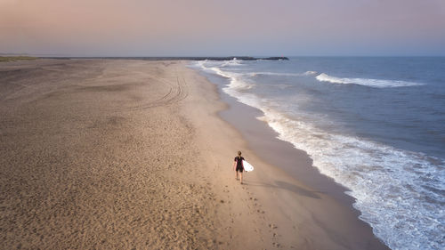 People on beach against sky