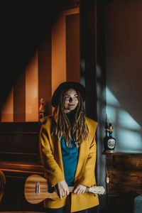 Portrait of young woman sitting in corridor