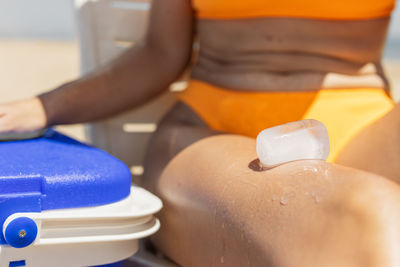 Midsection of woman holding dentures