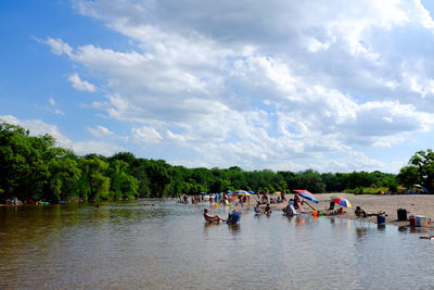 People on boat against sky
