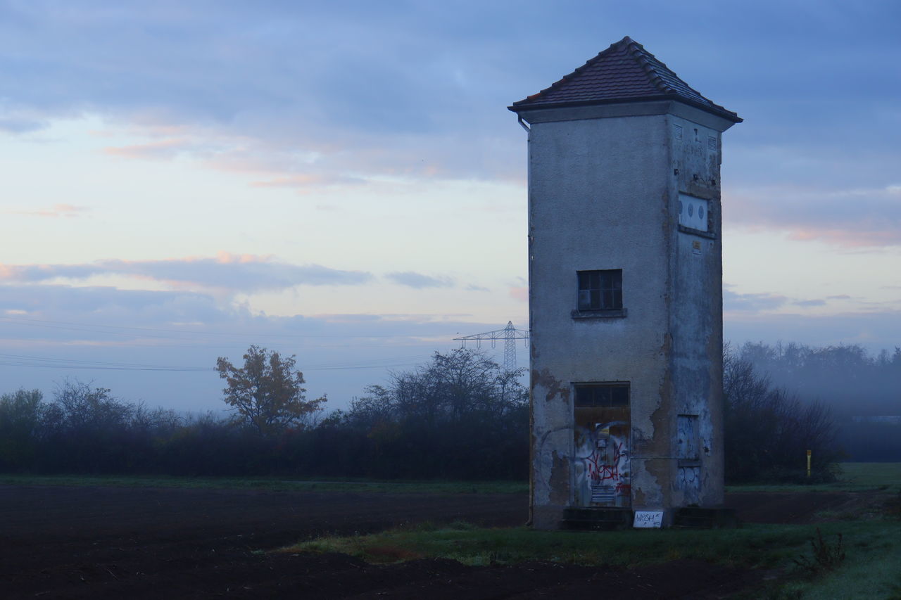 BUILT STRUCTURE ON FIELD AGAINST SKY