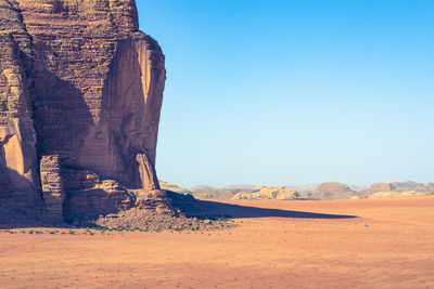 Scenic view of desert against clear blue sky