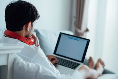 Midsection of man using mobile phone