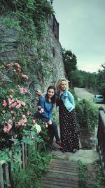 Full length of woman standing on footpath