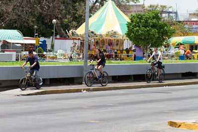 People riding bicycle on road