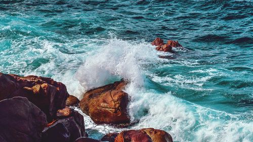 Waves splashing on rocks at shore