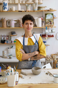 Successful ceramics studio or small business owner woman at workplace in pottery studio workshop