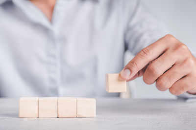 Midsection of man with toy on table