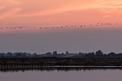 Scenic view of lake against sky during sunset