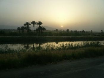 Scenic view of lake against sky during sunset