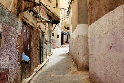 Narrow alley amidst buildings in city