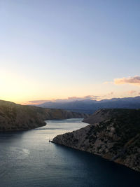 Scenic view of river against clear sky during sunset