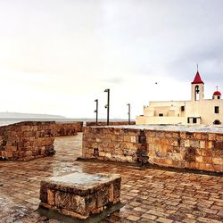 View of old building against cloudy sky