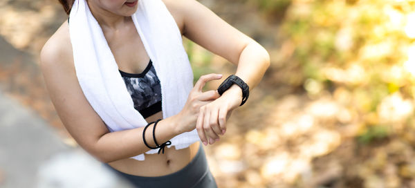 Midsection of woman holding camera