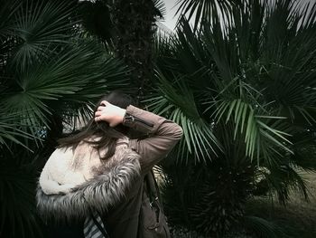 High angle view of young woman with palm tree