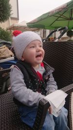 Cute baby girl sitting in park during winter