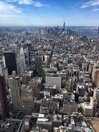 Aerial view of buildings in city against sky