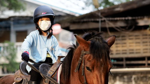 Portrait of man riding horse