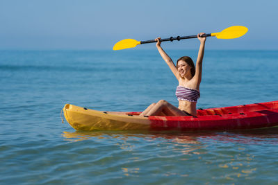 Man kayaking in sea