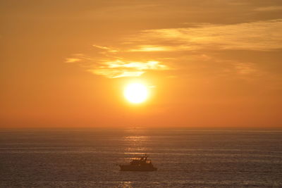 Scenic view of sea against orange sky