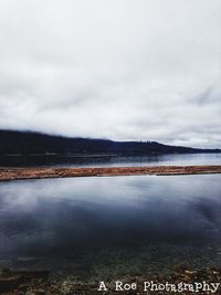 Scenic view of lake against sky during winter