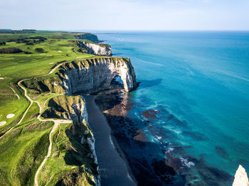 High angle view of rocks by sea against sky