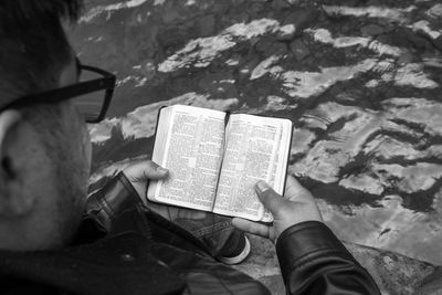 Low section of person holding book