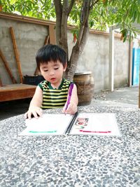 Boy writing on menu