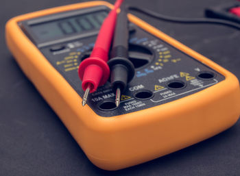 High angle view of multimeter with cables on table