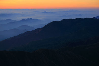 Scenic view of silhouette mountains against sky during sunset