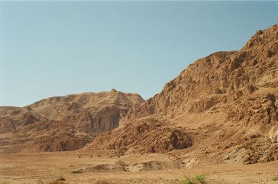 Scenic view of arid landscape against clear sky