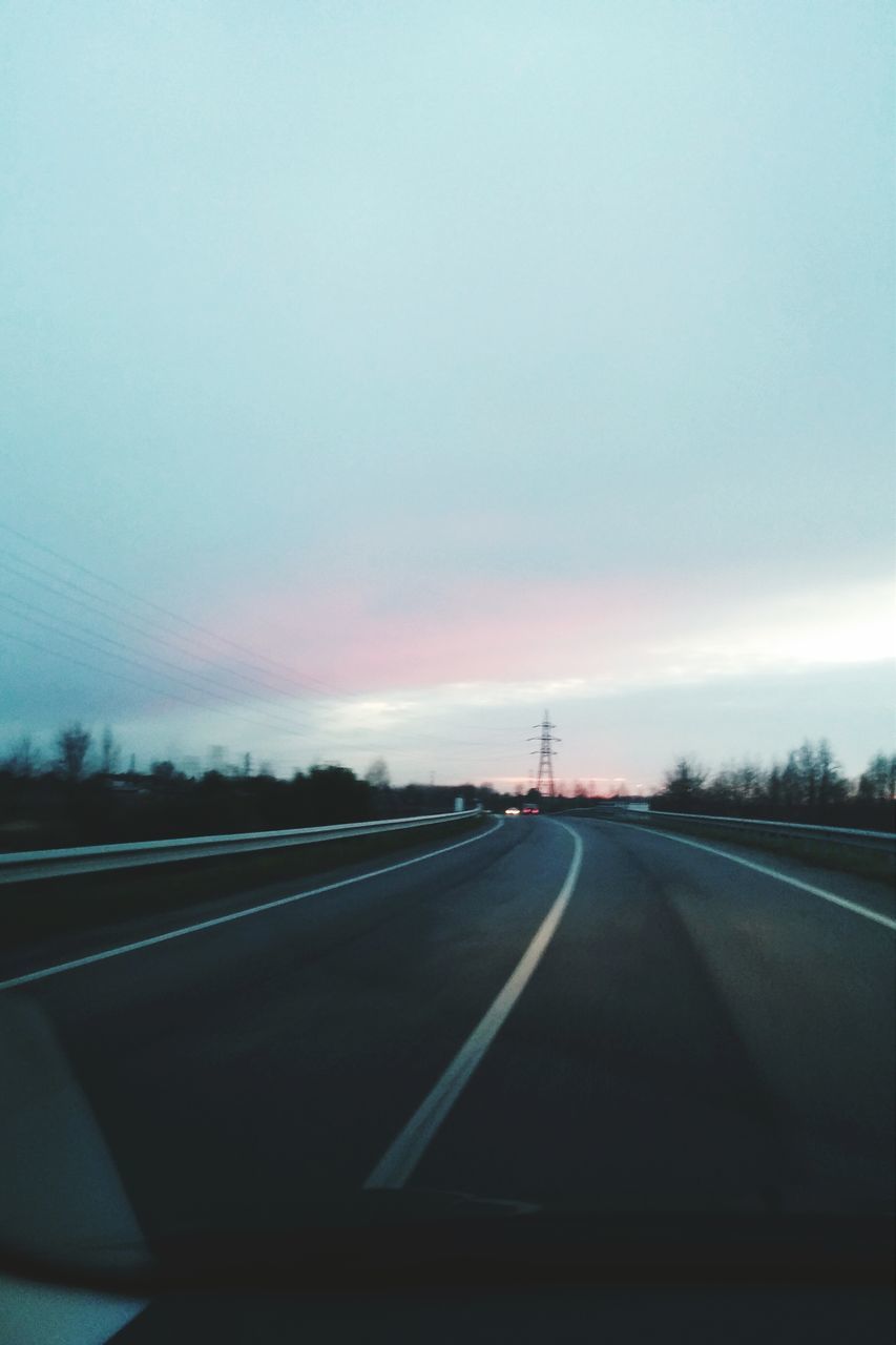 transportation, road, the way forward, road marking, diminishing perspective, sky, car, vanishing point, country road, mode of transport, windshield, land vehicle, highway, cloud - sky, street, empty, vehicle interior, car point of view, dividing line, travel